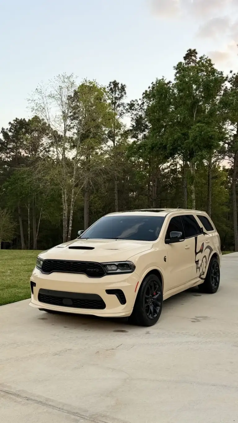 Cream Dodge Durango SRT with black graphics on a driveway