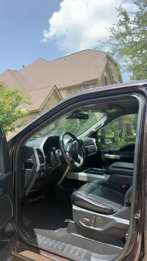 Clean Ford F-250 Super Duty cab: leather seat, steering wheel and floor after an interior detail