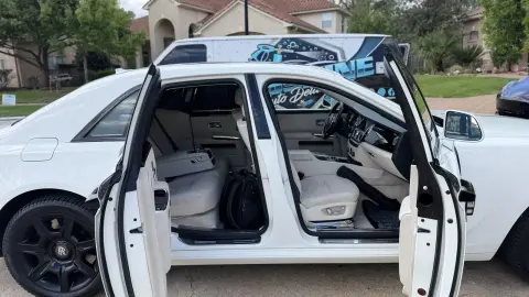 Rolls-Royce Ghost white leather interior with every door open during a detail